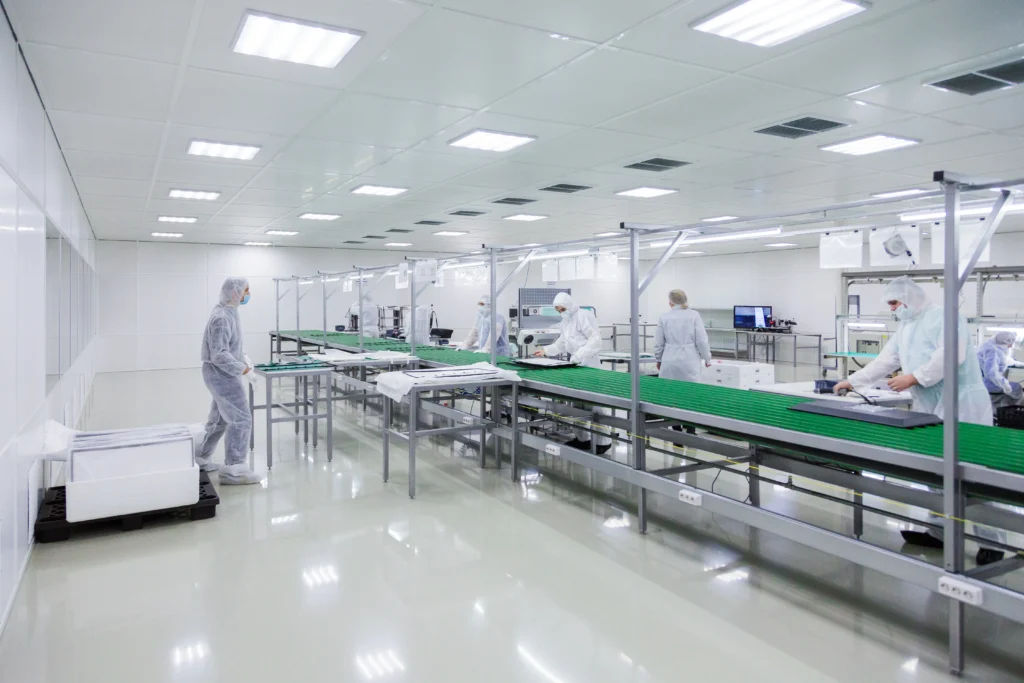 factory-workers-white-lab-suits-face-masks-producing-tv-sets-assebly-line-with-some-modern-equipment